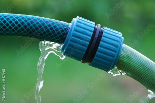 Connecting hoses for watering spray lawn grass in garden with plastic adapter