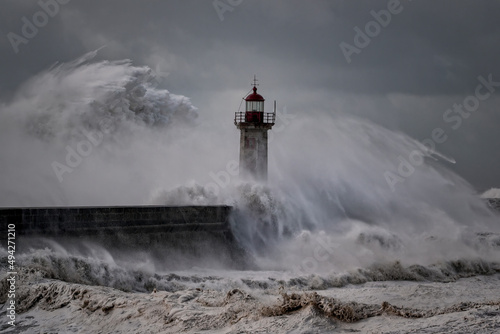 Stormy waves over old lighthouse