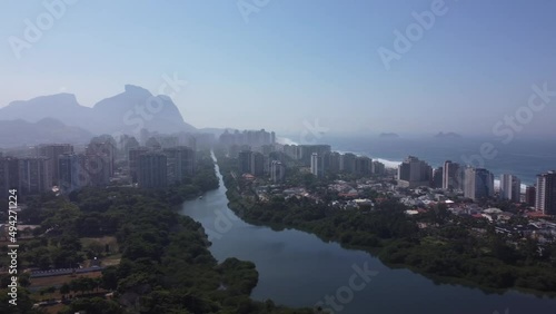 Amazing seaside town in the middle of the mountains with a river flowing by - Barra da Tijuca, Rio de Janeiro, RJ, Brazil - aerial drone view photo