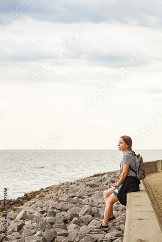 Beautiful girl on the sea with blue sky and clouds