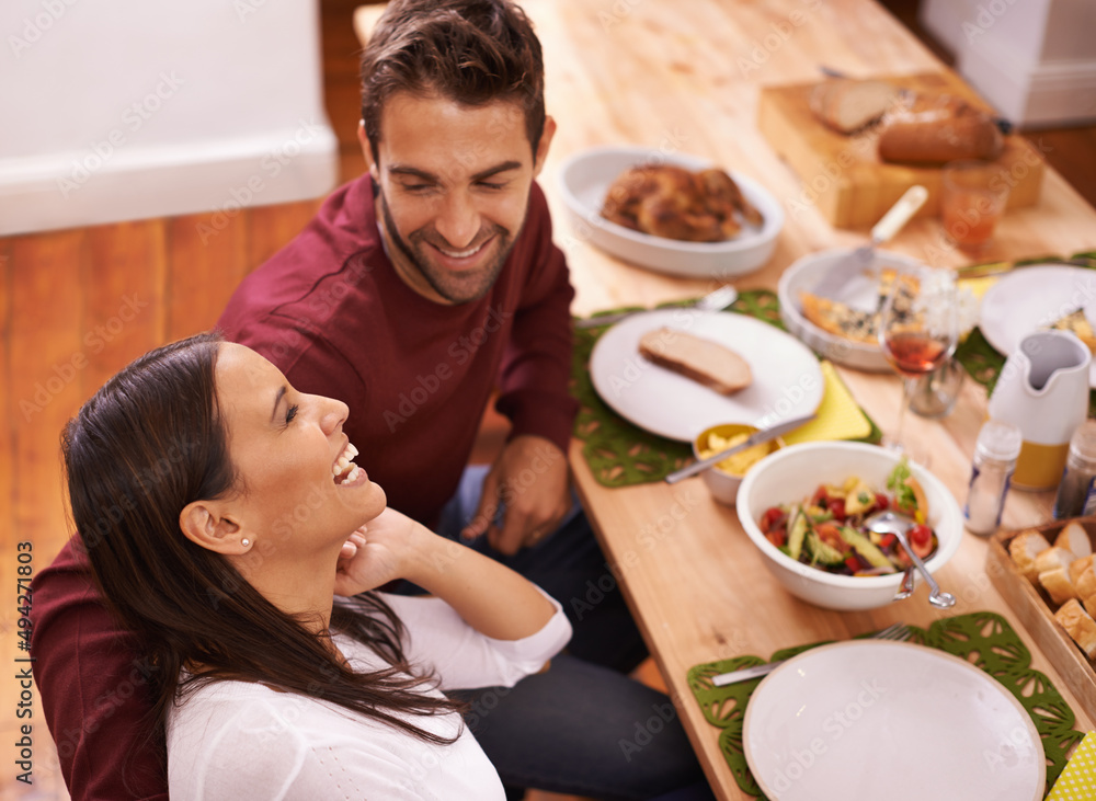 Love and food - two of the best things in life. A happy couple enjoying a family meal around the table. Love and food - two of the best things in life. A happy couple enjoying a family meal around the table.