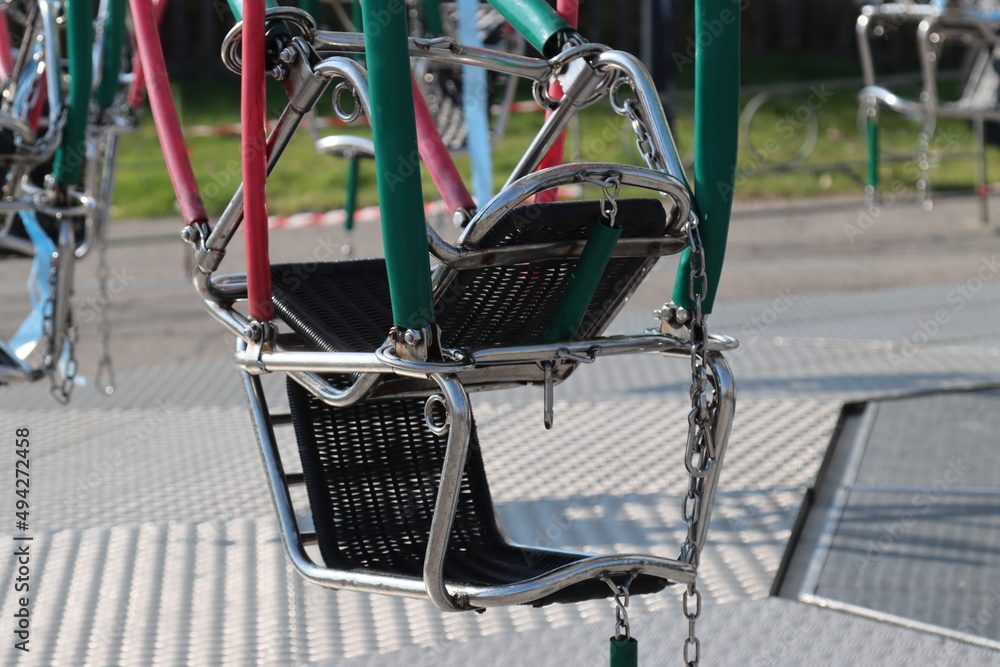 amusement park carousel with funfair seats-