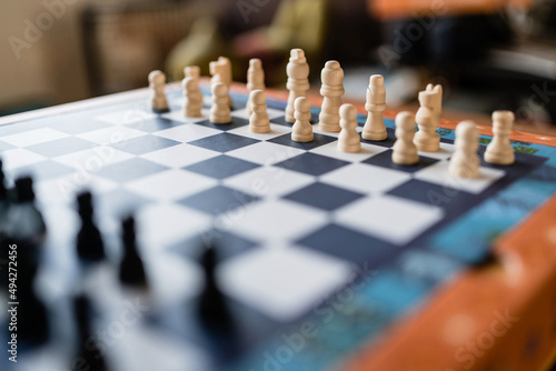 Chess piece set on the chessboard. Focus on the white side. Game on for challenge and strategic competition.
