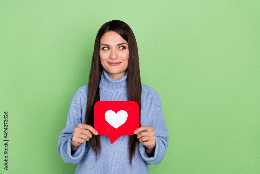 Photo of smart young brunette lady show like look advert wear blue sweater isolated on green color background Photo of smart young brunette lady show like look advert wear blue sweater isolated on green color background