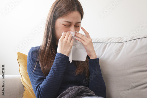 asian woman blowing nose and have allergy