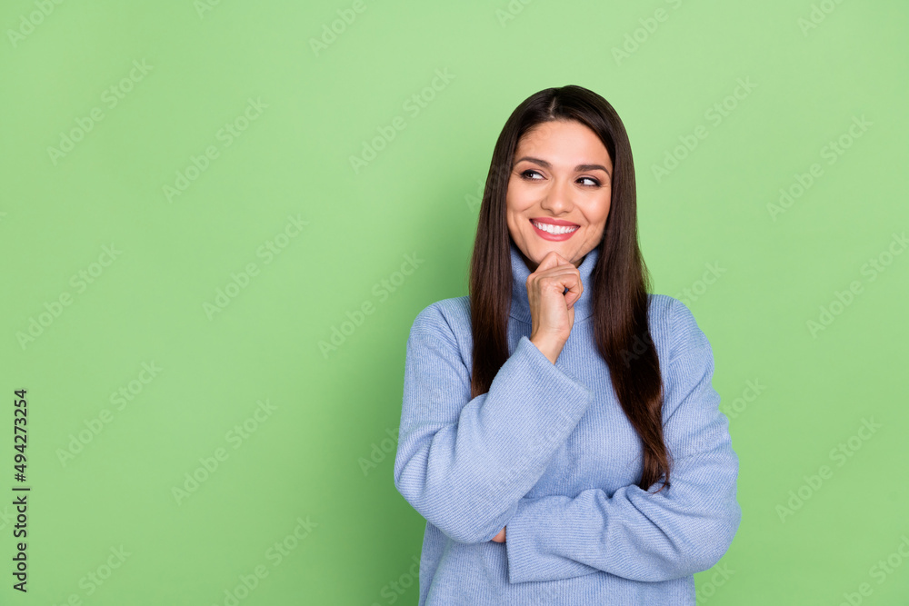 Photo of thoughtful pretty young woman wear blue sweater smiling looking empty space arm chin isolated green color background Photo of thoughtful pretty young woman wear blue sweater smiling looking empty space arm chin isolated green color background