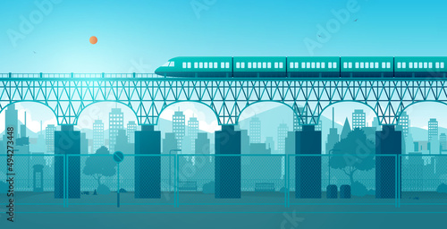 A train running on rails through the city with buildings in the background.