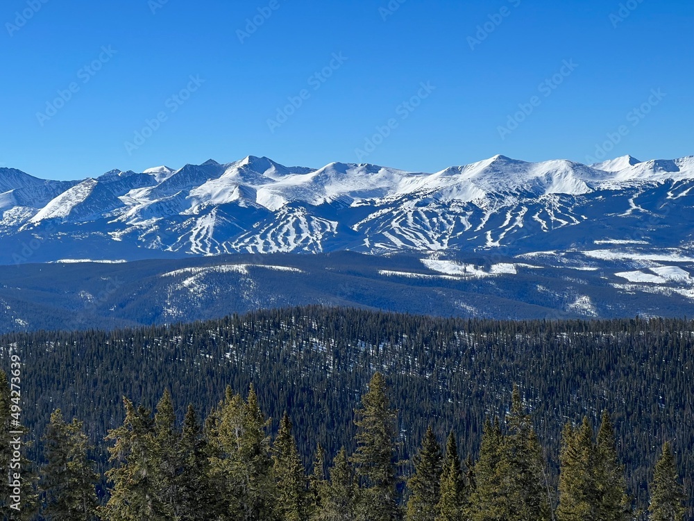 View of the snow covered Rocky Mountains on a sunny winter day in Colorado.