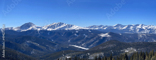 Range of snowy winter mountain peaks. Panorama landscape