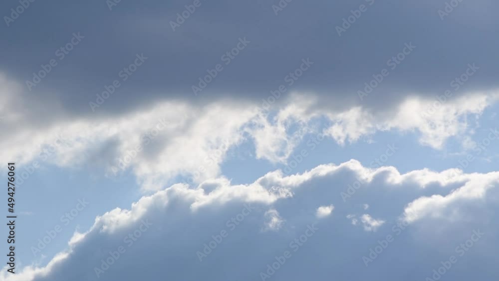 Cumulus cloud edges evaporating in close up, time lapse of dynamic clouds in atmosphere against blue sky Cumulus cloud edges evaporating in close up, time lapse of dynamic clouds in atmosphere against blue sky