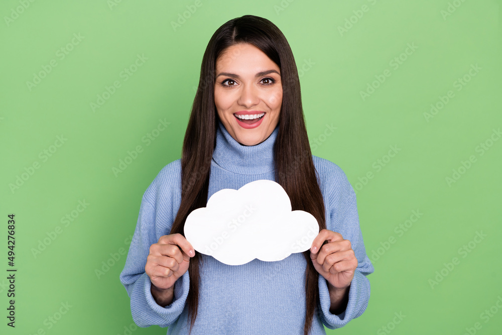 Photo of impressed mature brunette lady hold cloud wear blue turtleneck isolated on green color background Photo of impressed mature brunette lady hold cloud wear blue turtleneck isolated on green color background