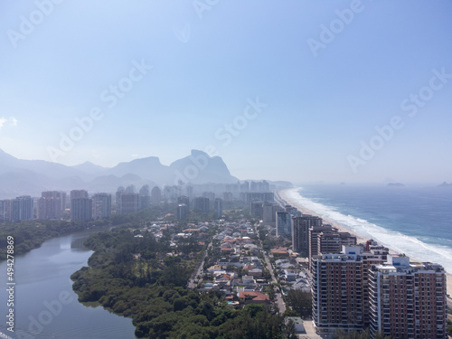 Amazing seaside town in the middle of the mountains with a river flowing - drone aerial view - Barra da Tijuca, Rio de Janeiro, RJ, Brazilian Beach