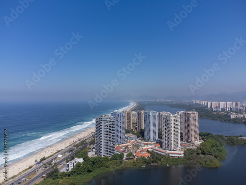 Amazing seaside town in the middle of the mountains with a river flowing - drone aerial view - Barra da Tijuca, Rio de Janeiro, RJ, Brazilian Beach