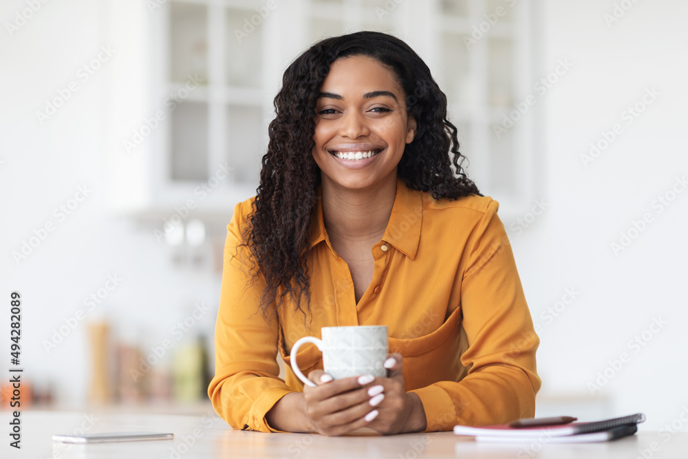Portrait of happy pretty black woman enjoying morning coffee Portrait of happy pretty black woman enjoying morning coffee