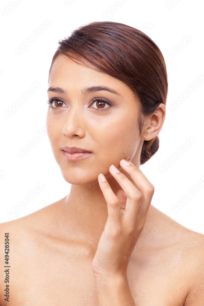 Seeing the rewards of great skincare. A beautiful young woman touching her cheek. Seeing the rewards of great skincare. A beautiful young woman touching her cheek.