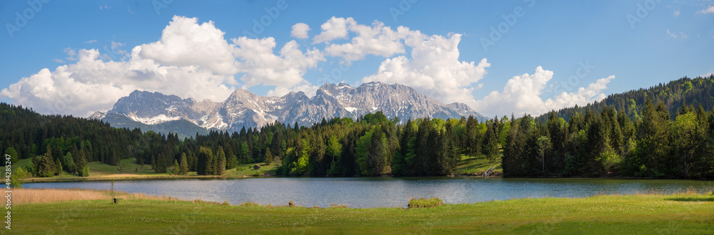 stunning view to Karwendel mountains and lake Gerold, blue sky with clouds