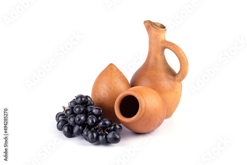 Georgian traditional clay vessel kvevri (qvevri ), jug(doqi) for wine and grapes on white isolated background.
