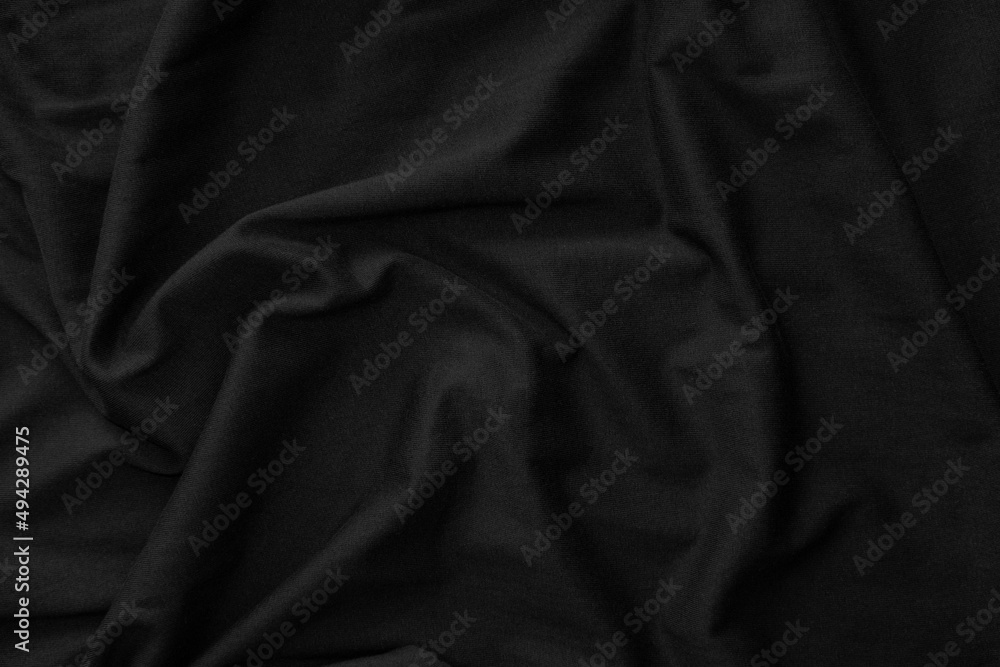 Black crumpled fabric texture. Dark background Black crumpled fabric texture. Dark background