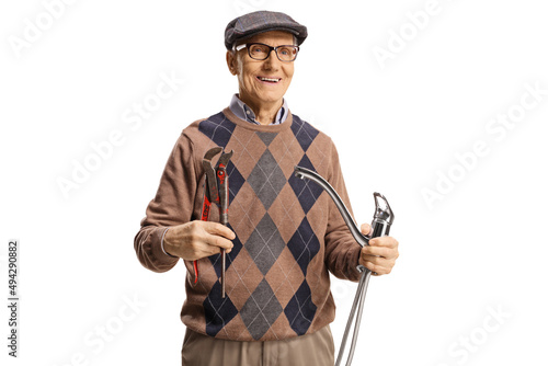 Smiling elderly man holding a steel hose and pliers