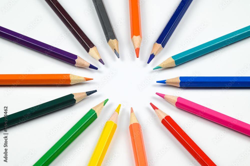 Multicolored pencils on a white,laid out in the shape of a circle Multicolored pencils on a white,laid out in the shape of a circle
