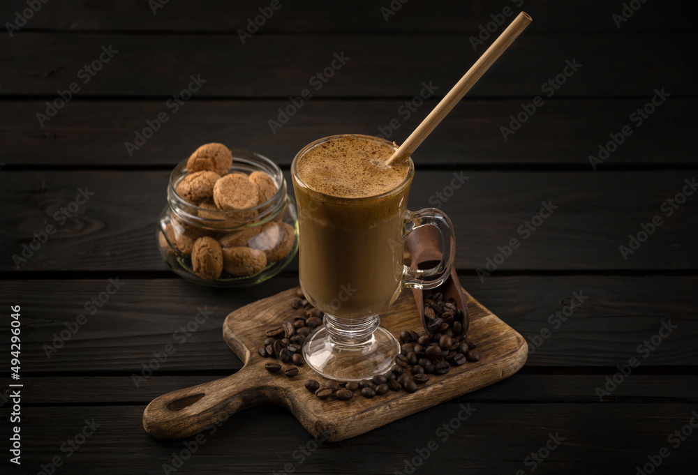 glass of whipped dalgona coffee with cookies glass of whipped dalgona coffee with cookies