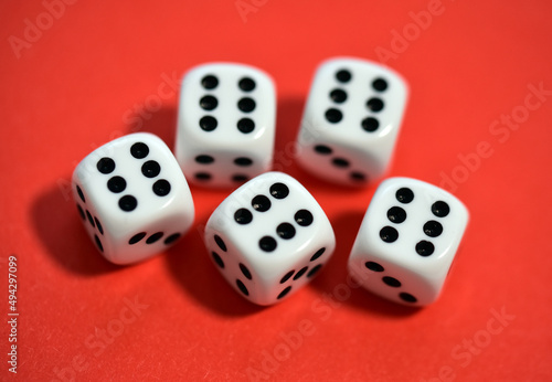 dice on red background close up
