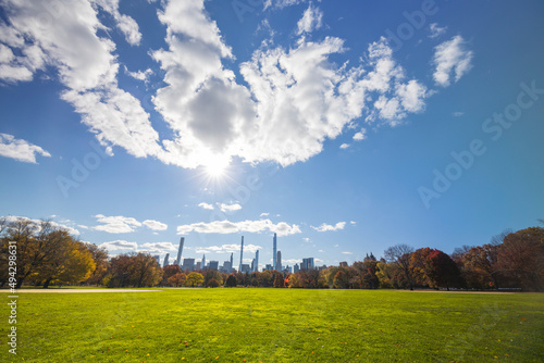 The sun shines over the Ultra-luxury high-rise residential skyscraper in Billionaires s Row beyond the Great Lawn in autumn on November 19  2021 at New York City NY USA.