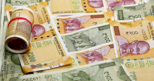 Indian 200,500 rupee note falls on the Indian notes on the table.