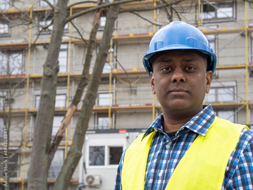 Portrait of a serious Indian engineer posing looking at the camera Portrait of a serious Indian engineer posing looking at the camera
