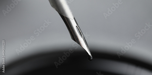 Black ink dripping from nib...