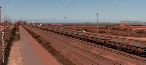 Saldanha Bay, West Coast, South Africa. 2022. Railway trucks carrying iron ore from Sishen to Saldanha Bay terminal on the West Coast of South Africa. photo