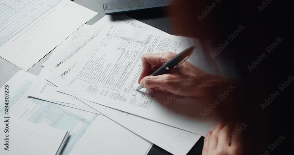 Woman filling US tax form 1040. tax form us business income office hand fill concept. Closeup Woman filling US tax form 1040. tax form us business income office hand fill concept. Closeup