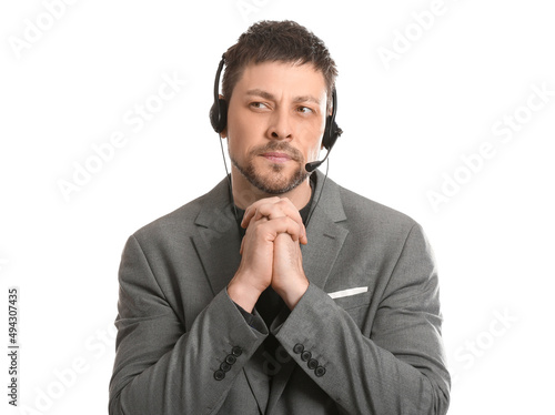 Thoughtful consultant of call center in suit with headset on white background