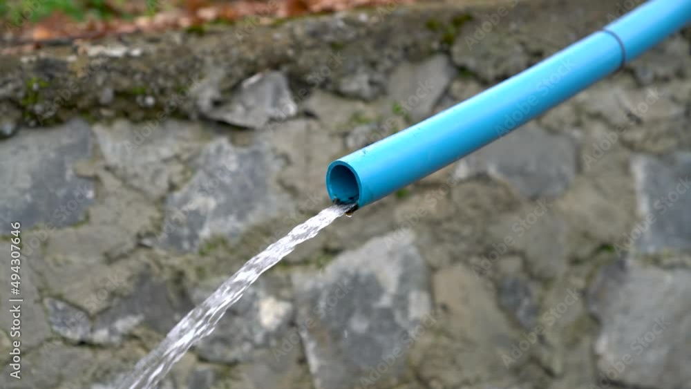 Water running from a blue water pipe, equipment agriculture. Water running from a blue water pipe, equipment agriculture.
