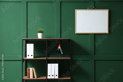 Photography Shelf unit with UAE flag and blank frame on color wall