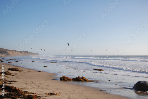 Kiteboarders enjoying a beautiful day in the Pacific Ocean, in Lompoc, Santa Barbara County, California.