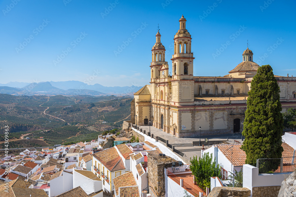 View of the beautiful white village of Olvera with the Church of Our Lady of the Incarnation, 18th century, in neoclassical style in the upper part of the city, Cadiz province, Andalusia, Spain
