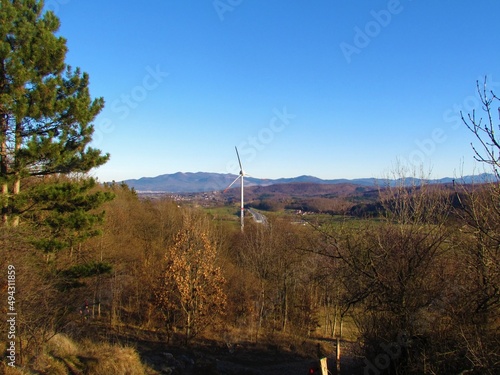 Wind turbine or wind energy converter under Nanos in Primorska or Littoral region of Slovenia with hills in the background
