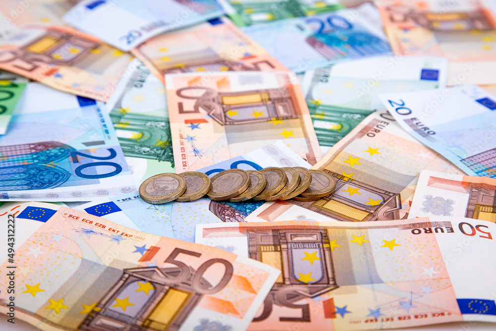 Background of banknotes and euro coins of different denominations close-up Background of banknotes and euro coins of different denominations close-up