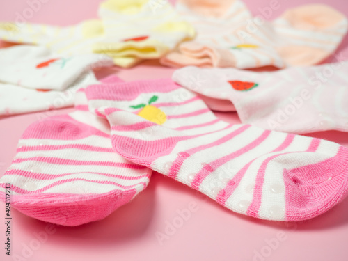 children's colorful socks on a pink background
