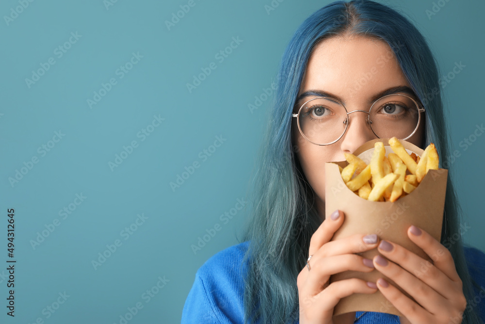 Young woman with unusual hair and french fries on color background Young woman with unusual hair and french fries on color background