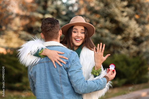 Happy young woman with ring...