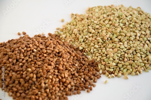 cereals of buckwheat and green unboiled buckwheat on a white background