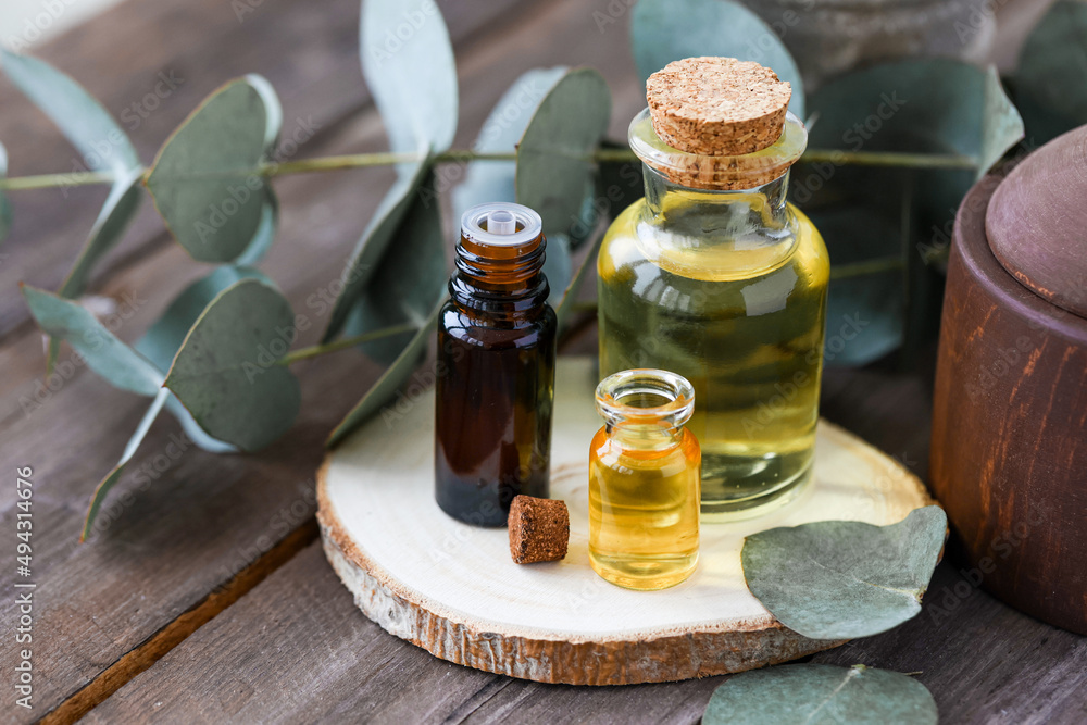 Assortment of natural oils in glass bottles on wooden background. Concept of pure organic ingredients in cosmetology. Bath accessories, atmosphere of harmony, relax. Close up macro. Healthy lifestyle Assortment of natural oils in glass bottles on wooden background. Concept of pure organic ingredients in cosmetology. Bath accessories, atmosphere of harmony, relax. Close up macro. Healthy lifestyle