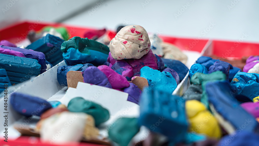Fototapeta premium Multi colored plasticine in cardboard box for children modeling and creating. Education and development conception.