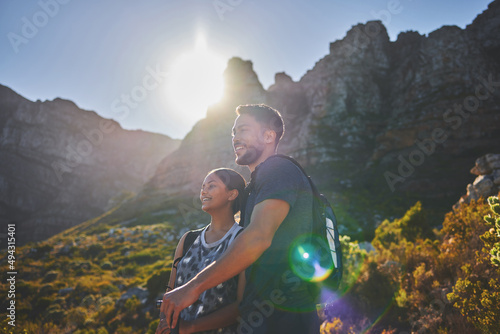 Fototapeta Naklejka Na Ścianę i Meble -  Hiking trails and sunny days. Shot of a young couple hiking on a mountain range outdoors.