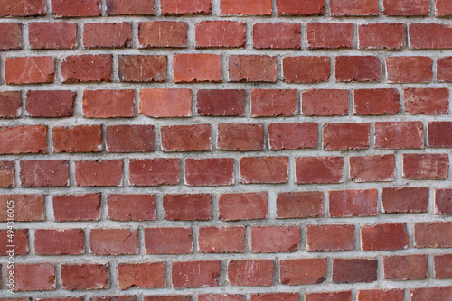 A typical red brick wall of a building holding together using mortar.
