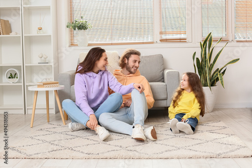 Young family sitting on sof...