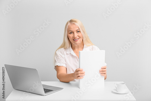 Mature secretary with paper...