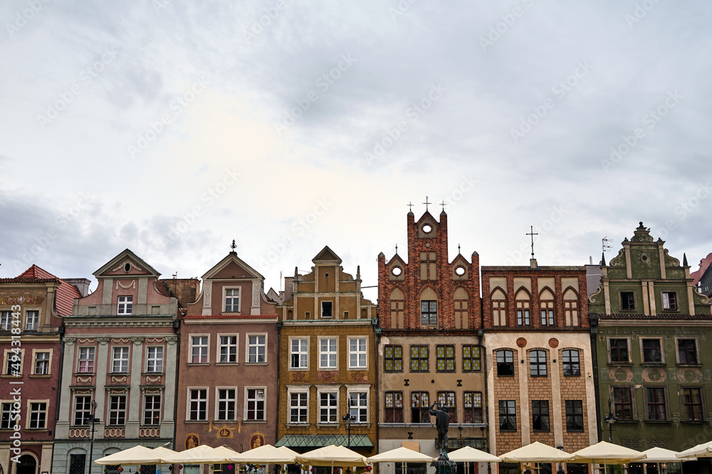 facades of historic tenement houses restaurant umbrellas on the market square